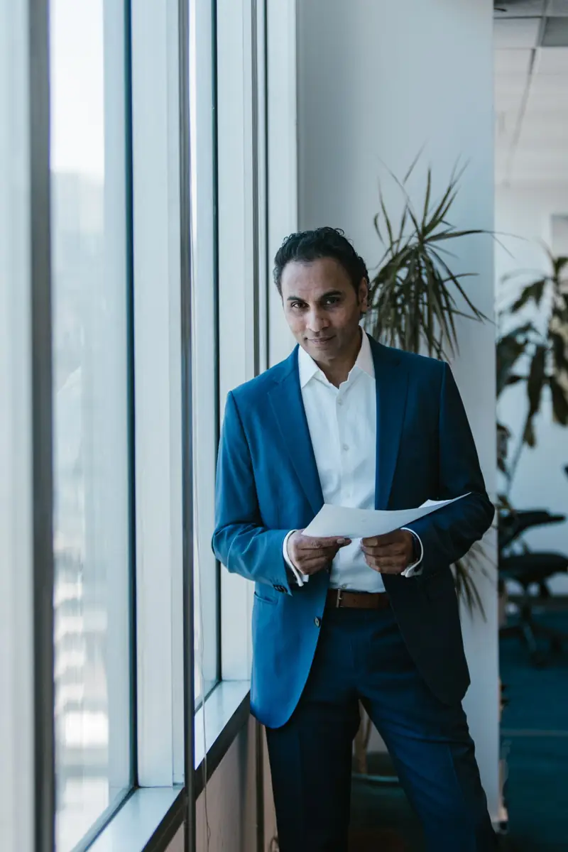 Partner reviewing a report by the office window